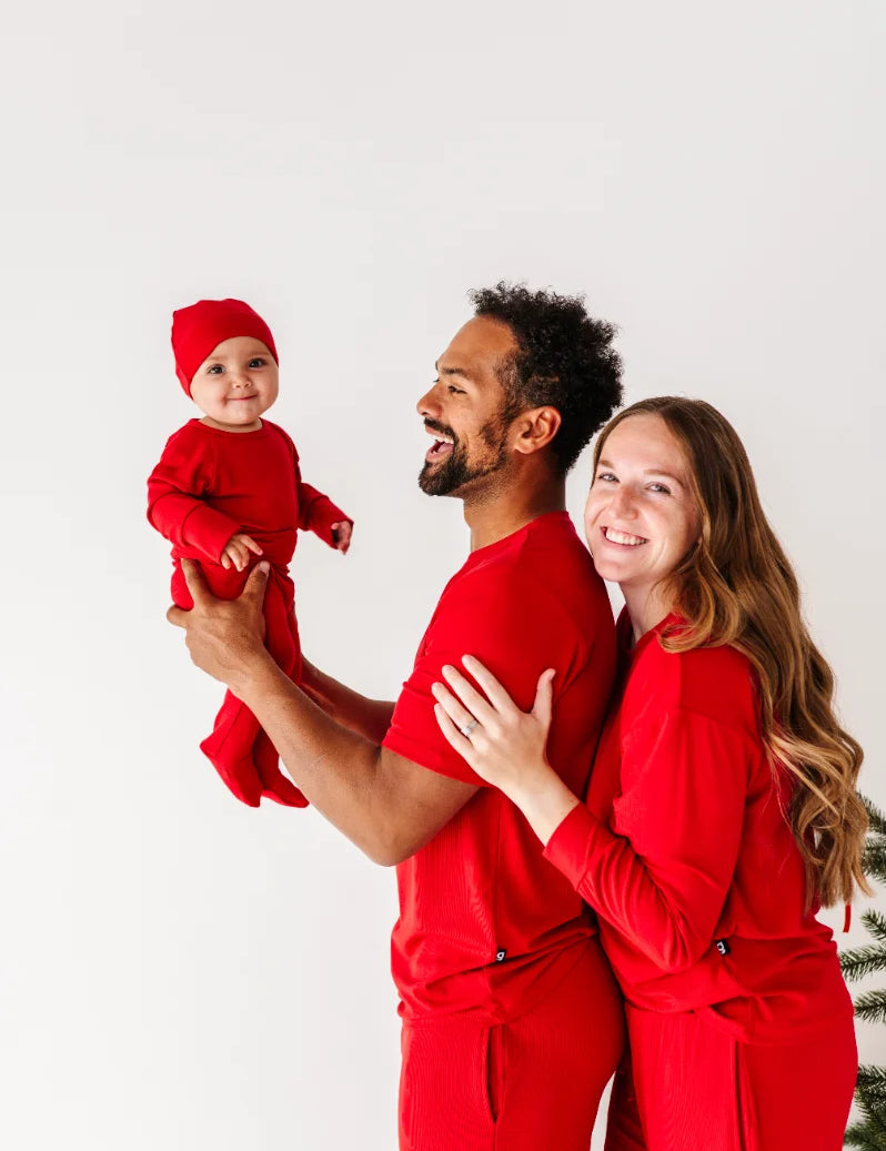 A parent snuggling their baby in soft pajamas