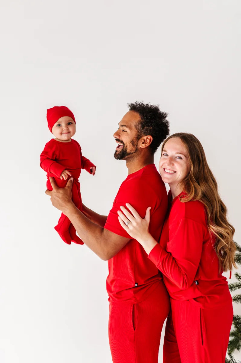 A parent snuggling their baby in soft pajamas