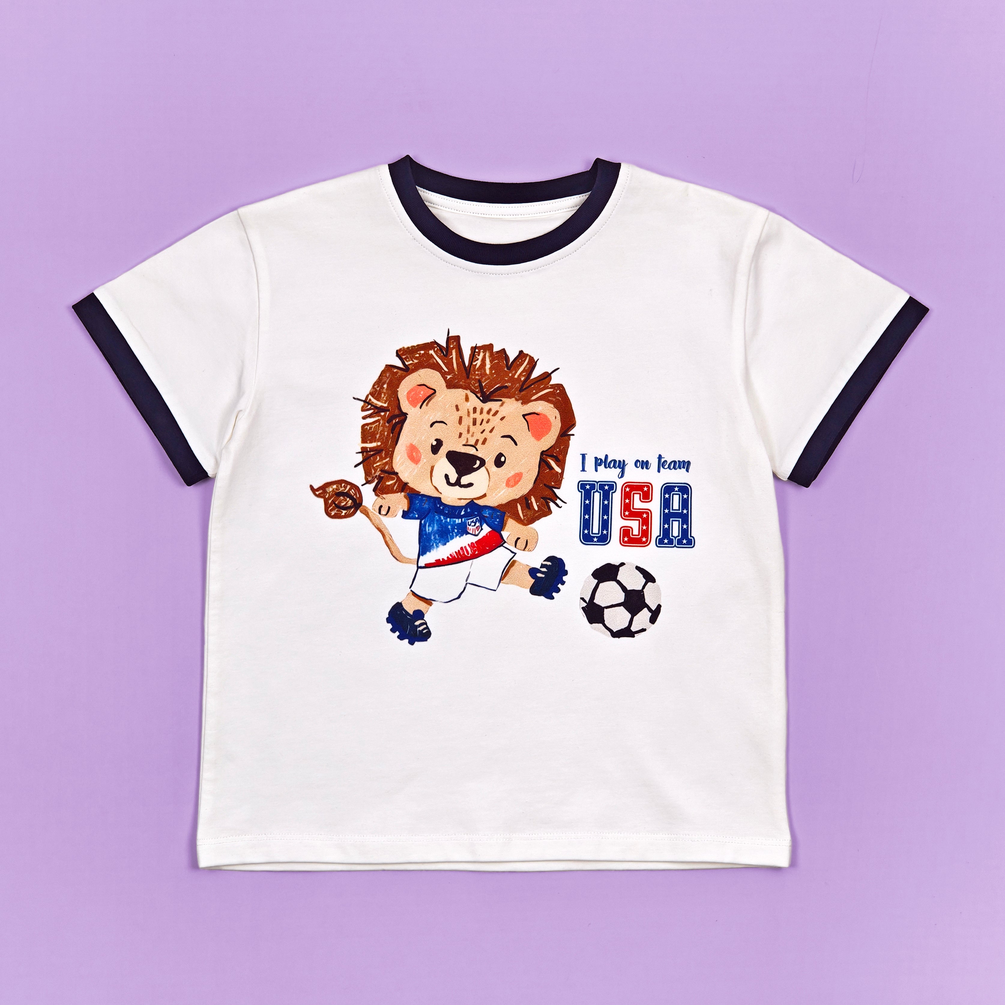 USA Zoo Champions soccer tee - lion mascot flat lay